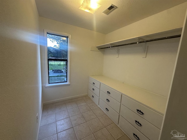 walk in closet featuring light tile patterned flooring