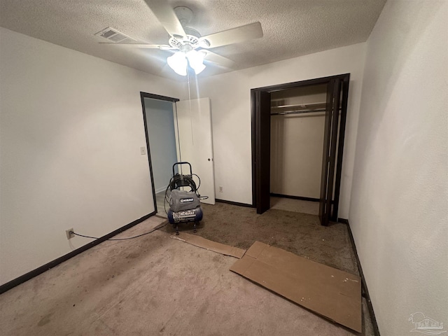 unfurnished bedroom featuring ceiling fan, light colored carpet, a closet, and a textured ceiling