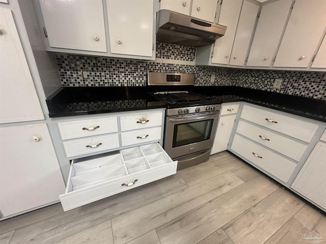 kitchen with white cabinets, stainless steel range with gas cooktop, backsplash, and light hardwood / wood-style flooring