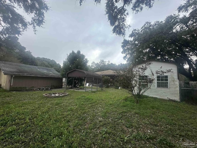 view of yard with an outdoor structure and a carport