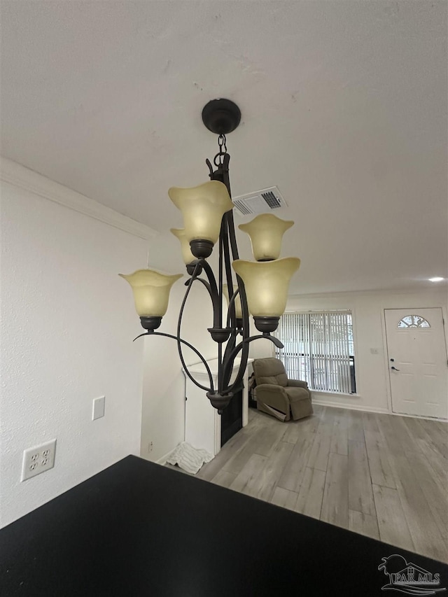 room details with wood-type flooring and crown molding