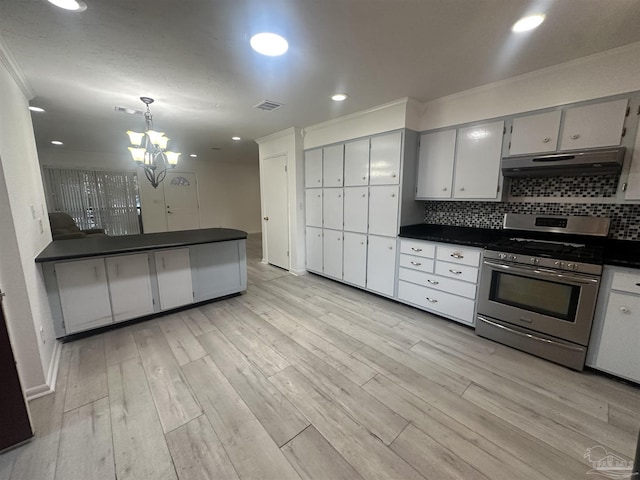 kitchen featuring stainless steel gas range, backsplash, decorative light fixtures, kitchen peninsula, and light wood-type flooring