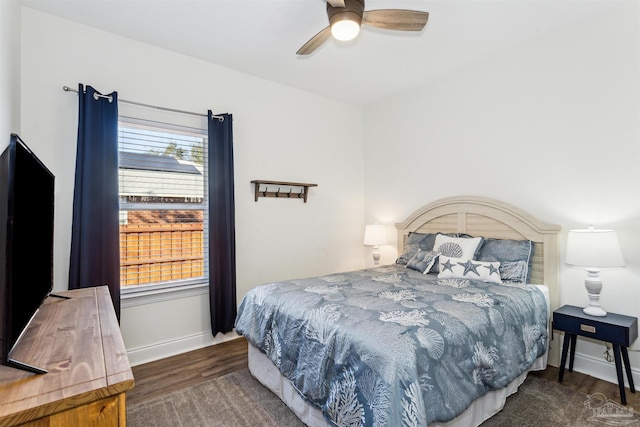 bedroom with ceiling fan and dark hardwood / wood-style flooring