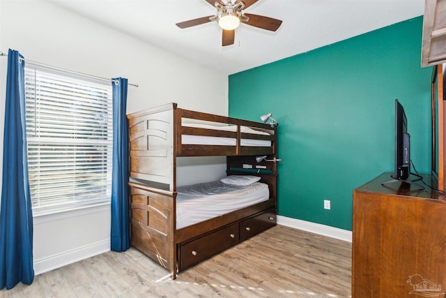 bedroom with ceiling fan and light hardwood / wood-style floors