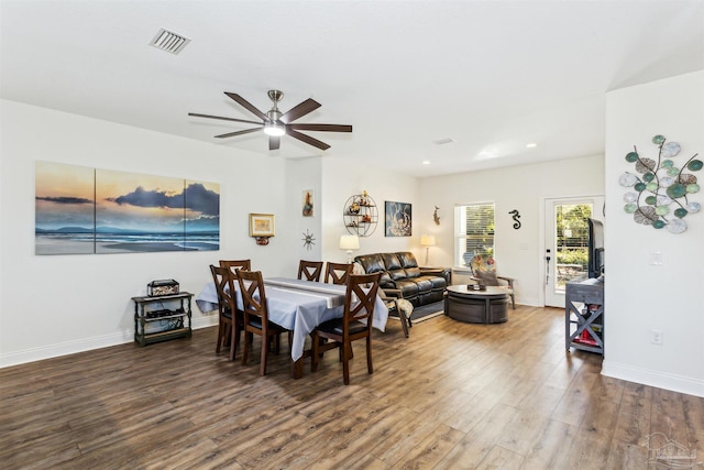 dining space with dark hardwood / wood-style floors and ceiling fan