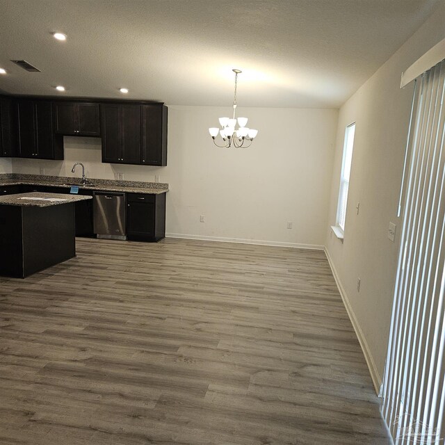 kitchen with sink, stainless steel dishwasher, light hardwood / wood-style floors, and decorative light fixtures