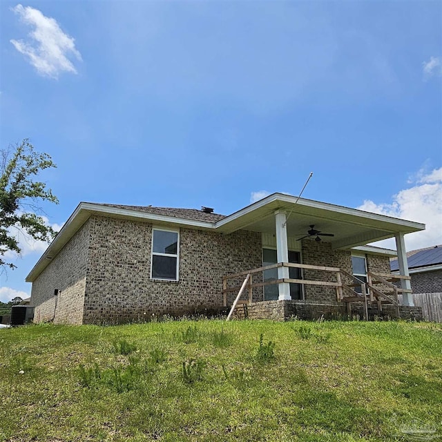 exterior space with ceiling fan and a front yard