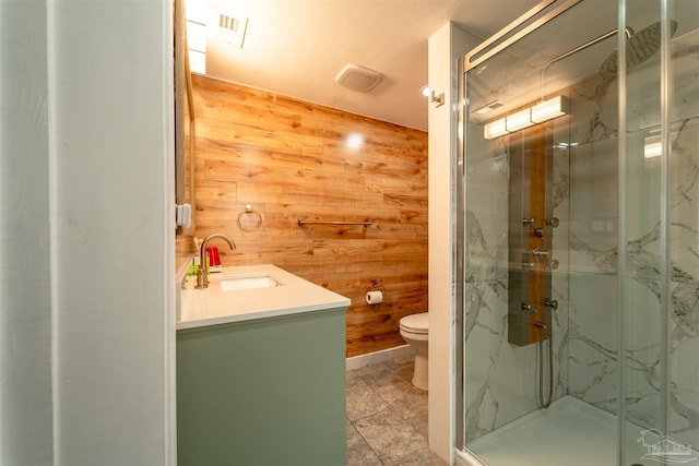 full bath featuring a marble finish shower, visible vents, toilet, wooden walls, and vanity