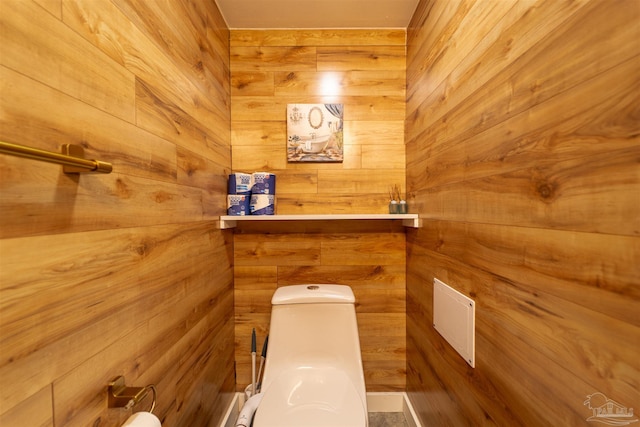 bathroom featuring a sauna, toilet, and wooden walls