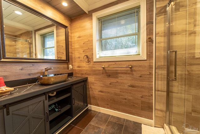 bathroom featuring a stall shower, wooden walls, baseboards, and vanity