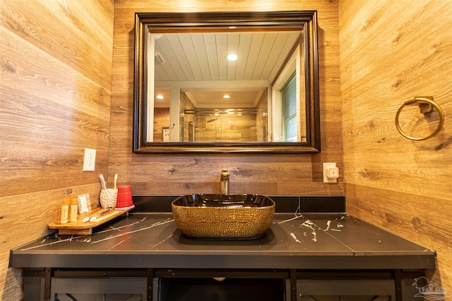 full bathroom with wooden ceiling, wood walls, and vanity