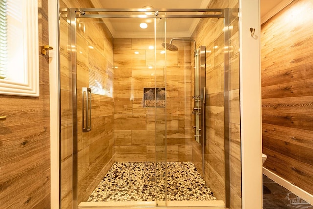 bathroom with a sauna, a stall shower, wood walls, and toilet