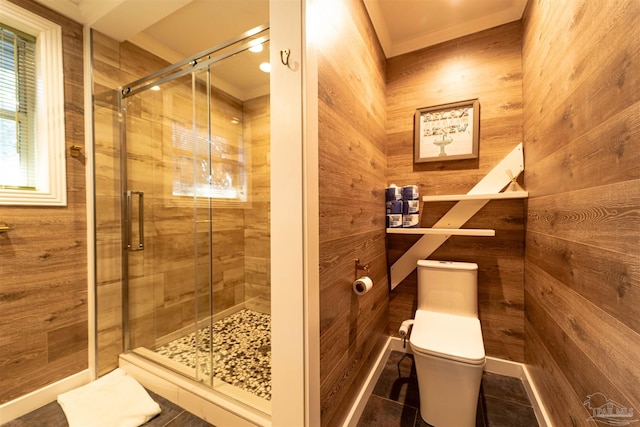 full bath with toilet, a stall shower, and wood walls