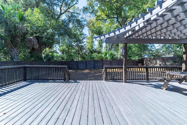 deck featuring a fenced backyard and a pergola