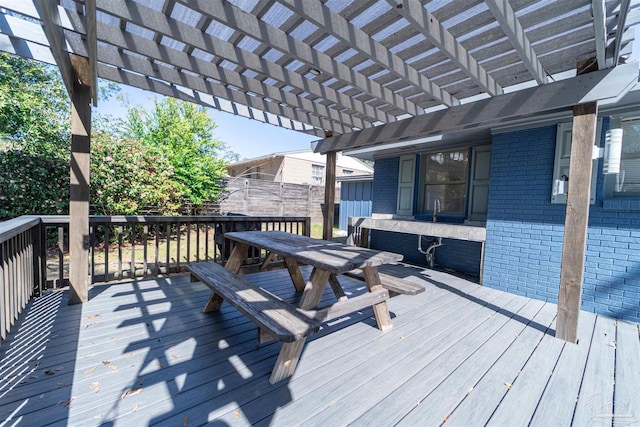 wooden deck featuring outdoor dining area and a pergola