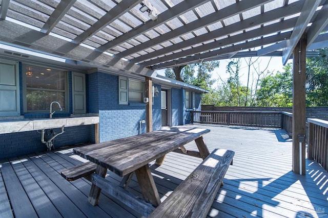 wooden deck featuring outdoor dining space and a pergola