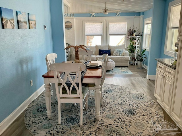dining area featuring light wood-style floors, baseboards, and ceiling fan