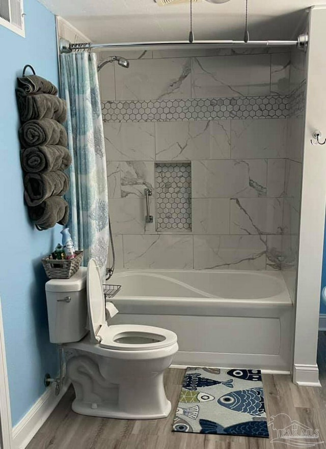 full bathroom featuring toilet, visible vents, shower / bath combination with curtain, and wood finished floors