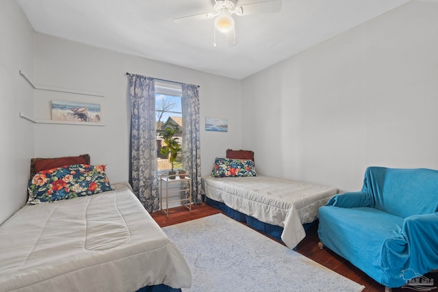 bedroom with ceiling fan and hardwood / wood-style flooring