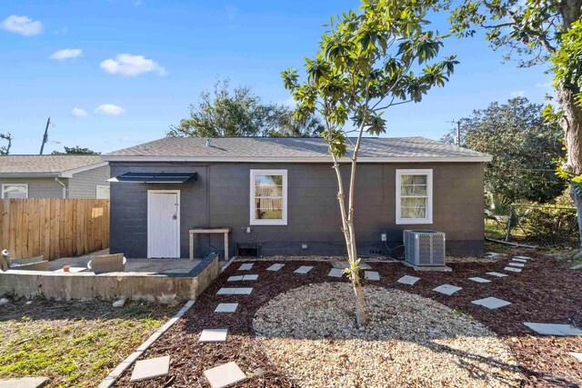 rear view of house featuring central AC unit