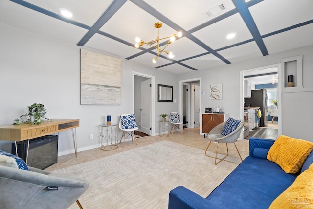 living room featuring tile patterned floors, coffered ceiling, and a notable chandelier