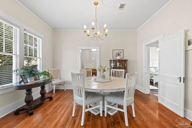1703 E Avery St, Pensacola, FL 32503 - dining room with ornamental molding, wood finished floors, and a chandelier