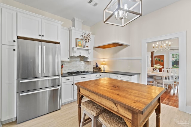 1703 E Avery St, Pensacola, FL 32503 - kitchen with stainless steel appliances, a chandelier, dark countertops, and decorative backsplash