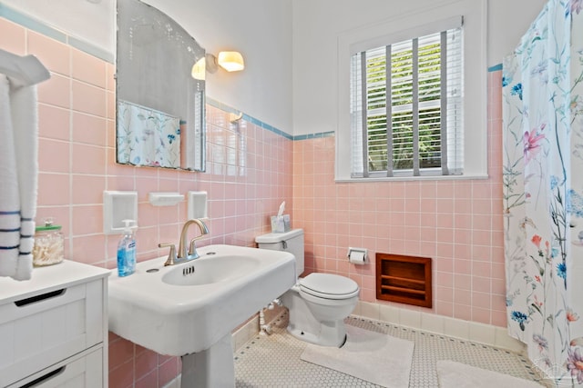 1703 E Avery St, Pensacola, FL 32503 - bathroom with tile walls, tile patterned flooring, and a shower with shower curtain