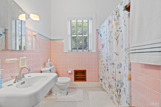 1703 E Avery St, Pensacola, FL 32503 - bathroom with tile walls, tile patterned flooring, a shower with curtain, and a wainscoted wall