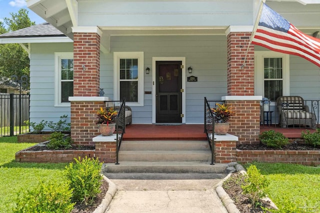 1703 E Avery St, Pensacola, FL 32503 - doorway to property with covered porch and brick siding