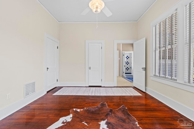 1703 E Avery St, Pensacola, FL 32503 - unfurnished bedroom with ornamental molding, multiple windows, wood finished floors, and ceiling fan