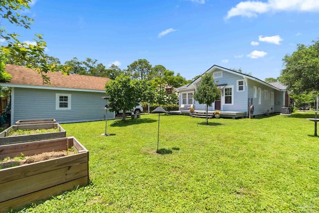 1703 E Avery St, Pensacola, FL 32503 - view of grassy yard featuring a vegetable garden and a deck