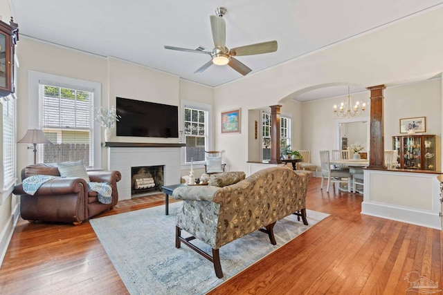 1703 E Avery St, Pensacola, FL 32503 - living area featuring ornate columns, arched walkways, a chandelier, hardwood / wood-style flooring, and a ceiling fan