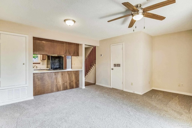 kitchen featuring light carpet and ceiling fan