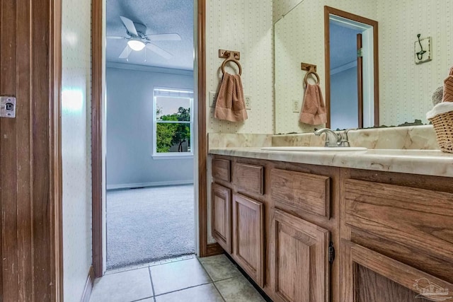 bathroom featuring vanity, tile patterned floors, ceiling fan, and crown molding