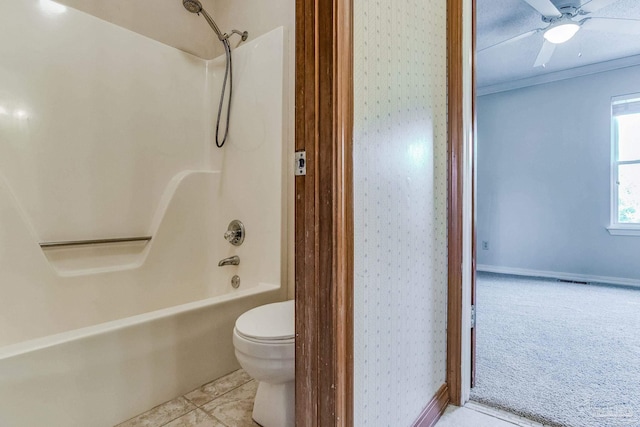 bathroom with tub / shower combination, toilet, ceiling fan, and tile patterned flooring