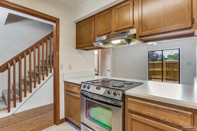 kitchen with light hardwood / wood-style flooring and stainless steel stove