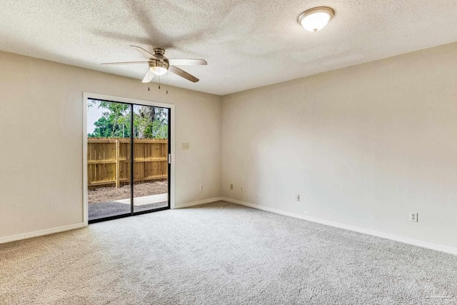 carpeted empty room featuring ceiling fan and a textured ceiling