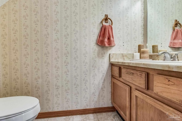 bathroom featuring vanity, tile patterned flooring, and toilet