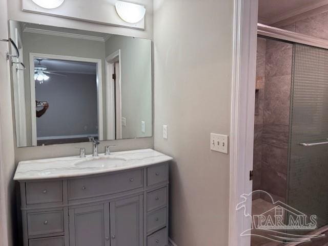 full bathroom with a shower stall, ornamental molding, and vanity