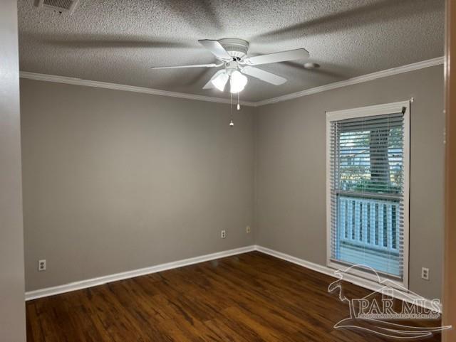 empty room with baseboards, wood finished floors, a ceiling fan, and crown molding