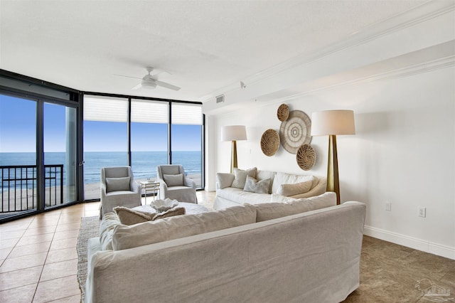 17075 Perdido Key Dr Unit 4E, Pensacola, FL 32507 - tiled living area featuring a ceiling fan, expansive windows, a water view, and baseboards