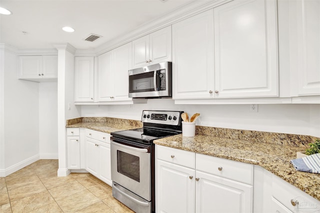17075 Perdido Key Dr Unit 4E, Pensacola, FL 32507 - kitchen featuring appliances with stainless steel finishes, baseboards, white cabinets, recessed lighting, and light stone countertops