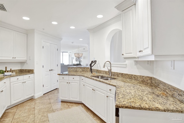 17075 Perdido Key Dr Unit 4E, Pensacola, FL 32507 - kitchen featuring a sink, white cabinets, light stone counters, and recessed lighting