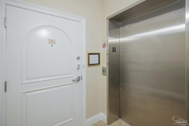 17075 Perdido Key Dr Unit 4E, Pensacola, FL 32507 - doorway to outside with elevator and baseboards