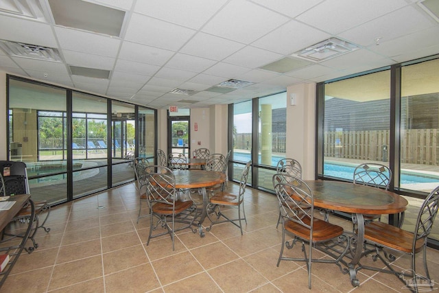 17075 Perdido Key Dr Unit 4E, Pensacola, FL 32507 - tiled dining space with healthy amount of natural light, a paneled ceiling, and expansive windows