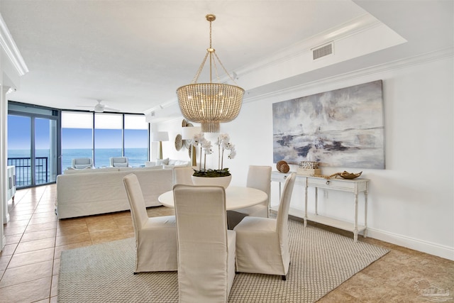 17075 Perdido Key Dr Unit 4E, Pensacola, FL 32507 - dining space featuring a chandelier, a ceiling fan, light tile patterned flooring, ornamental molding, and a water view