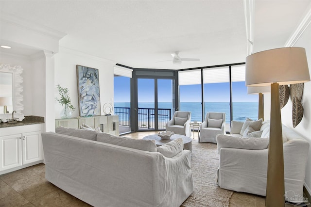 17075 Perdido Key Dr Unit 4E, Pensacola, FL 32507 - living area with crown molding, a water view, a ceiling fan, floor to ceiling windows, and tile patterned flooring