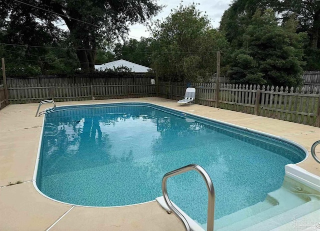 view of swimming pool featuring a fenced backyard and a fenced in pool