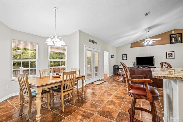 dining space featuring ceiling fan with notable chandelier, french doors, a textured ceiling, and vaulted ceiling